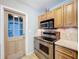 The kitchen features stainless steel appliances and light wood cabinets at 10754 63Rd Ave, Seminole, FL 33772