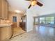 Open concept kitchen with tile floor, wood cabinets, stainless steel refrigerator, with view of the living room at 10754 63Rd Ave, Seminole, FL 33772