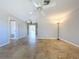 Bright living room showcasing tile floors, neutral paint, and access to a hallway and other living areas at 10754 63Rd Ave, Seminole, FL 33772