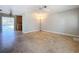 View of large living room with travertine floors leading to dining area and kitchen with pool views at 10754 63Rd Ave, Seminole, FL 33772