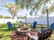 A cozy fire pit is surrounded by chairs, making it an ideal spot for outdoor gatherings and relaxation in the backyard at 10864 90Th Ter, Seminole, FL 33772