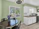 Charming kitchen nook with modern fixtures, a cozy table, and bright natural light from the window at 10864 90Th Ter, Seminole, FL 33772