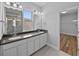 Bathroom featuring double vanity, framed mirrors, and glass-enclosed shower at 11503 Quiet Forest Dr, Tampa, FL 33635