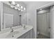 Bathroom featuring double sink vanity, and tub with shower at 11503 Quiet Forest Dr, Tampa, FL 33635