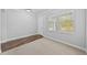 Bright bedroom with carpet, wood floors, two windows, and fresh paint at 11503 Quiet Forest Dr, Tampa, FL 33635