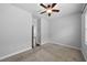 Simple bedroom featuring neutral carpet, ceiling fan and windows with blinds at 11503 Quiet Forest Dr, Tampa, FL 33635