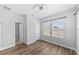 Bedroom with laminate wood flooring, ceiling fan, and two windows at 11503 Quiet Forest Dr, Tampa, FL 33635