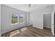 Bedroom with hardwood floors, two windows, and access to an adjoining room at 11503 Quiet Forest Dr, Tampa, FL 33635
