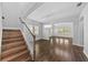 Staircase leading to an open floor plan dining room featuring hardwood floors and chandelier at 11503 Quiet Forest Dr, Tampa, FL 33635