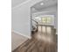 Inviting entryway featuring hardwood floors, staircase, and open floorplan bathed in natural light at 11503 Quiet Forest Dr, Tampa, FL 33635