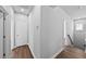 Hallway with luxury vinyl plank flooring, neutral paint and access to bedrooms at 11503 Quiet Forest Dr, Tampa, FL 33635