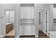 Hallway featuring white cabinets, granite countertops, and hardwood flooring at 11503 Quiet Forest Dr, Tampa, FL 33635