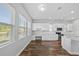Eat-in kitchen featuring wood floors, lots of windows, a work space, and stainless appliances at 11503 Quiet Forest Dr, Tampa, FL 33635