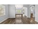 Bright living room features wood floors, chandelier, and multiple windows at 11503 Quiet Forest Dr, Tampa, FL 33635
