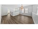 Spacious loft area with hardwood floors and a modern chandelier at 11503 Quiet Forest Dr, Tampa, FL 33635