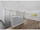 Spacious loft area with hardwood floors and a modern chandelier at 11503 Quiet Forest Dr, Tampa, FL 33635