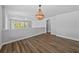 Spacious loft area with hardwood floors and a modern chandelier at 11503 Quiet Forest Dr, Tampa, FL 33635
