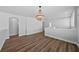 Spacious loft area with hardwood floors and a modern chandelier at 11503 Quiet Forest Dr, Tampa, FL 33635