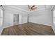 A beautiful main bedroom suite with hardwood floors, tray ceilings, ceiling fan, and natural light at 11503 Quiet Forest Dr, Tampa, FL 33635
