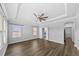 Spacious main bedroom suite with hardwood floors, tray ceiling, ceiling fan, and ensuite bath at 11503 Quiet Forest Dr, Tampa, FL 33635