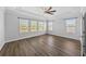 Main bedroom with hardwood floors, tray ceilings, ceiling fan, and lots of natural light at 11503 Quiet Forest Dr, Tampa, FL 33635