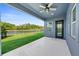 Covered patio with ceiling fan, view of the backyard, and access to the house at 11503 Quiet Forest Dr, Tampa, FL 33635