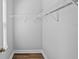 Walk-in closet with hardwood floors and metal rack system at 11503 Quiet Forest Dr, Tampa, FL 33635