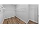 Walk-in closet boasts shelving and laminate wood flooring at 11503 Quiet Forest Dr, Tampa, FL 33635