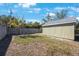 View of a backyard featuring a grassy area, perimeter fencing, and an outbuilding at 1160 36Th N Ave, St Petersburg, FL 33704