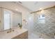 Modern bathroom with marble walls, glass shower, with decorative green leaf pattern wall at 1160 36Th N Ave, St Petersburg, FL 33704