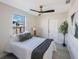 Well-lit bedroom with a ceiling fan, a comfortable bed, and a glimpse of the outdoor scenery at 1160 36Th N Ave, St Petersburg, FL 33704