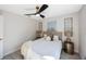 Serene bedroom with decorative wall art, ceiling fan, and cozy bedding at 1160 36Th N Ave, St Petersburg, FL 33704