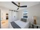 Cozy bedroom featuring a comfortable bed, modern ceiling fan, and white sliding door with black hardware at 1160 36Th N Ave, St Petersburg, FL 33704