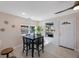 Dining area featuring a modern black table set, natural light from the window, and sleek ceiling fan at 1160 36Th N Ave, St Petersburg, FL 33704