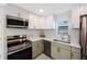 Kitchen featuring two-tone cabinets and stainless steel appliances at 1160 36Th N Ave, St Petersburg, FL 33704