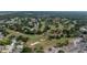 Aerial view of golf course running through a residential area with a lake in the background at 118 Stafford Dr, Palm Harbor, FL 34684