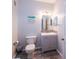 Bathroom features a modern vanity, toilet, mirror and coastal decor at 1226 S Missouri Ave # 1013, Clearwater, FL 33756