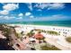 Beautiful beach view with palm trees, white sands, and clear blue ocean water at 1226 S Missouri Ave # 1013, Clearwater, FL 33756