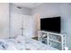 Bedroom features a TV on a stand, beach-themed decor, a bed, and wood-look floors at 1226 S Missouri Ave # 1013, Clearwater, FL 33756