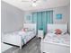 Bedroom with two beds has nautical decor, wood-look flooring and bright natural light at 1226 S Missouri Ave # 1013, Clearwater, FL 33756