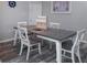 Dining room features an extendable wood table, white chairs, decor and flooring at 1226 S Missouri Ave # 1013, Clearwater, FL 33756