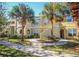 Well-maintained building exterior with mature palm trees and lush lawn at 1226 S Missouri Ave # 1013, Clearwater, FL 33756