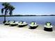 Row of jet skis parked along the beach with calm waters and blue skies at 1226 S Missouri Ave # 1013, Clearwater, FL 33756