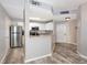 Well-lit kitchen with stainless steel appliances, breakfast bar, and wood-look flooring at 1226 S Missouri Ave # 1013, Clearwater, FL 33756