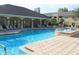 Community pool area with lounge chairs, hot tub, and a covered patio at 1226 S Missouri Ave # 1013, Clearwater, FL 33756