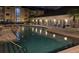 Community pool and hot tub area at night with outdoor seating and building in background at 1226 S Missouri Ave # 1013, Clearwater, FL 33756
