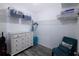 Spacious walk-in closet features white dresser, chair, shelving and wood-look floors at 1226 S Missouri Ave # 1013, Clearwater, FL 33756