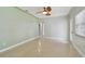 Bright bedroom with a ceiling fan, light walls, terrazzo floors, and a window at 1231 27Th S Ave, St Petersburg, FL 33705