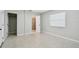 Bedroom with closet and bathroom, featuring a window with blinds and neutral wall paint at 1231 27Th S Ave, St Petersburg, FL 33705