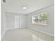 Bright bedroom with built-in shelves, light walls, and terrazzo floors at 1231 27Th S Ave, St Petersburg, FL 33705